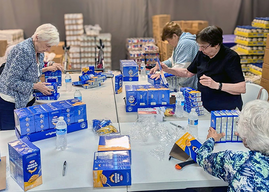 Residents from The Boulevard Senior Living Wentzville volunteer with a local food initiative.
