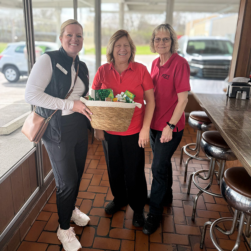 A Boulevard of Wentzville team member presents a large gift basket to local business owners.